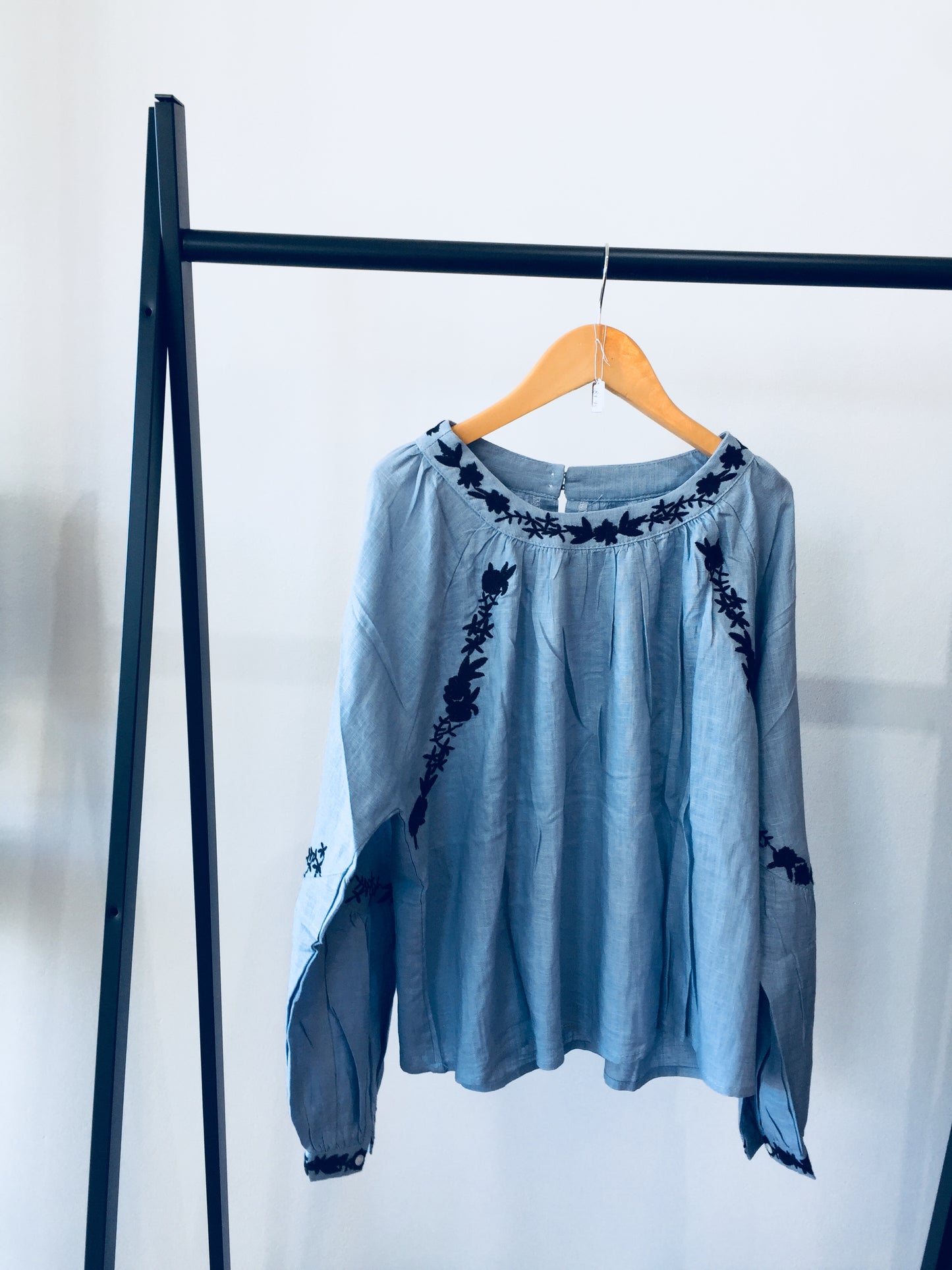 Light Wash Blue Linen Shirt With Black Floral Hand Embroidered Detail.