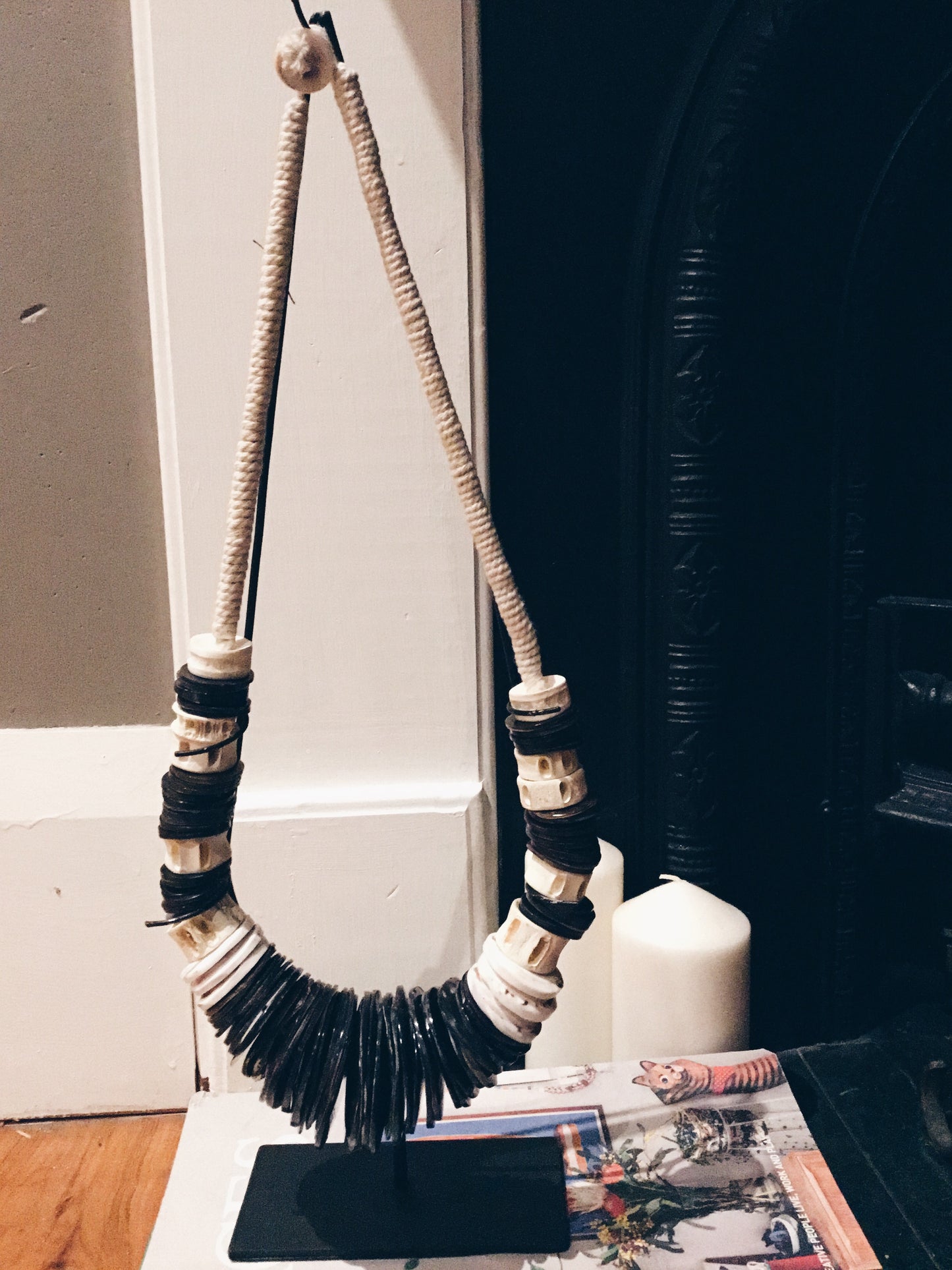 BLACK AND WHITE TRIBAL PEACE NECKLACE ON STAND
